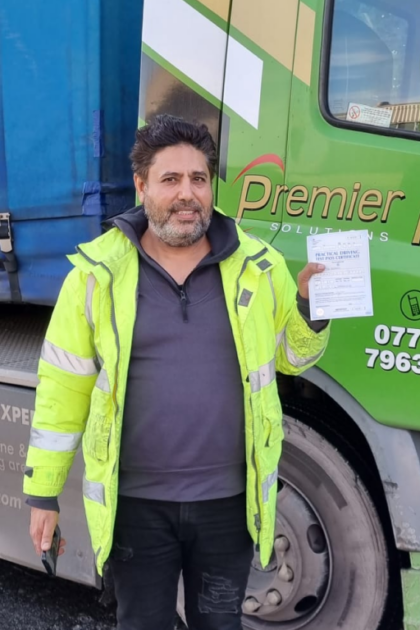 Man holding pass cerificate for HGV Driver Training Category C+E with PFS Training