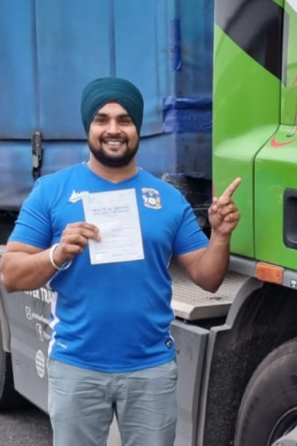 Man holding pass cerificate for HGV Driver Training Category C+E with PFS Training