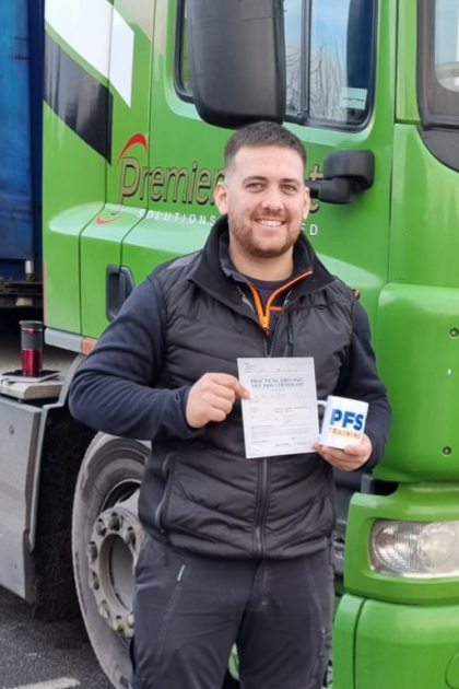 Man holding pass cerificate for HGV Driver Training Category C+E with PFS Training